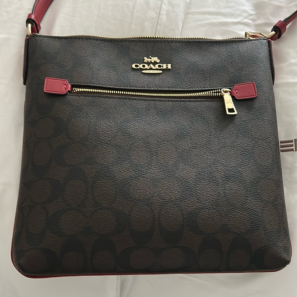 Coach crossbody leather bag, brown coach print with red detail